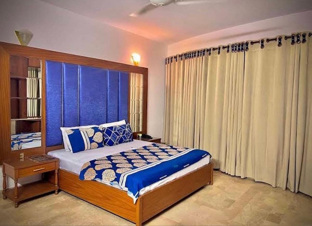 Deluxe Room alternate view with blue headboard and blue bedding
