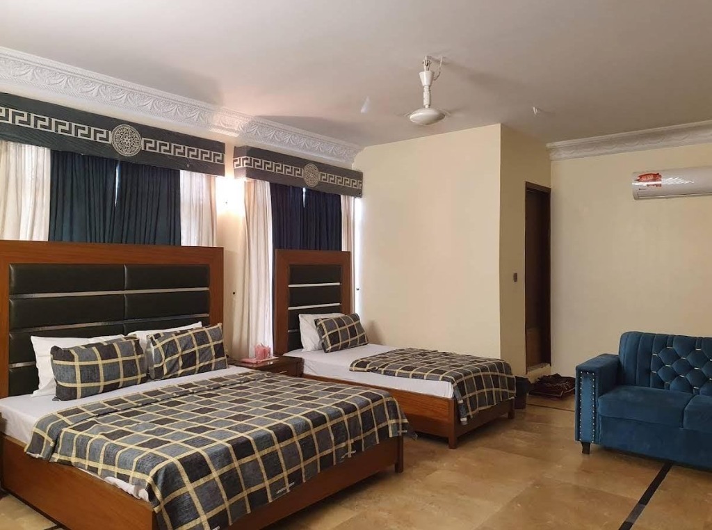 Family Room with double and single bed, blue sofa, spacious layout