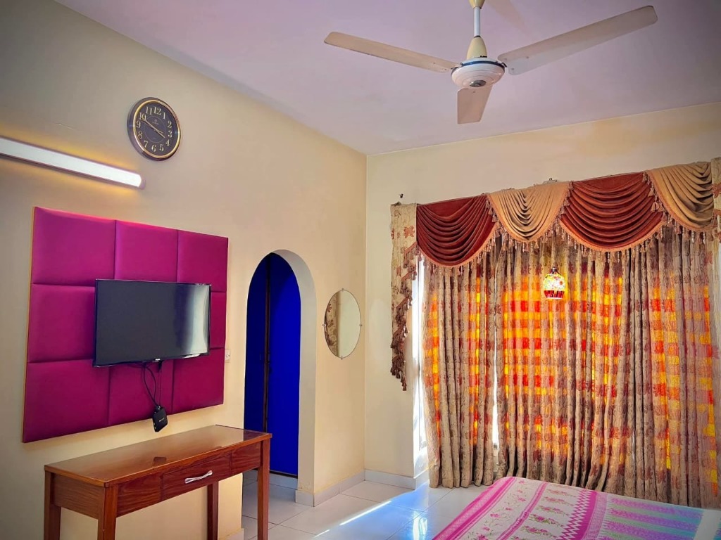 Room with two beds and brown headboard