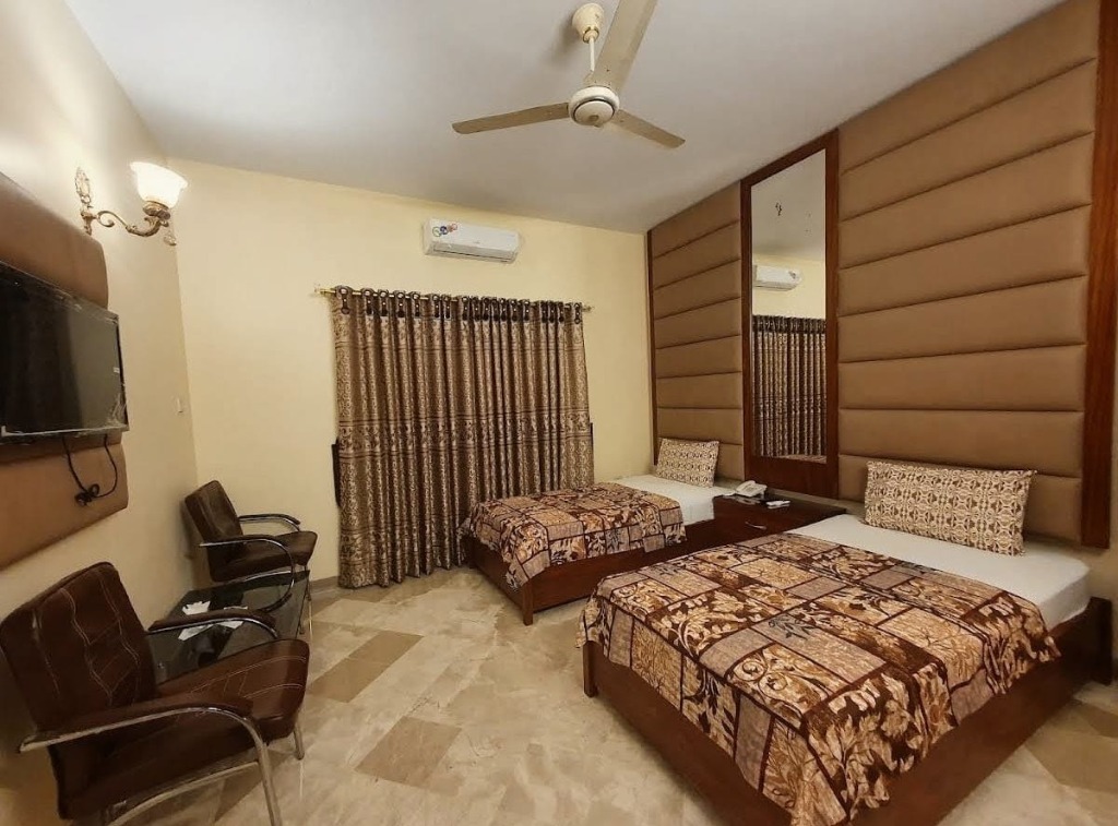Room with pink wall panel and TV